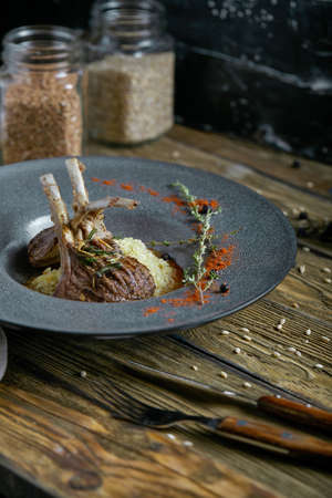 Rack of lamb with polenta. Low key, copyspace, rustic styleの写真素材