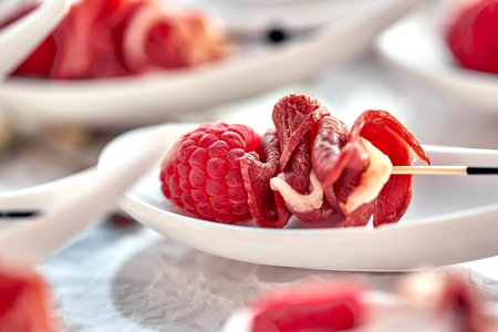Delicious canapes hamon with raspberries. Concept of food, restaurant, catering, menu.の写真素材