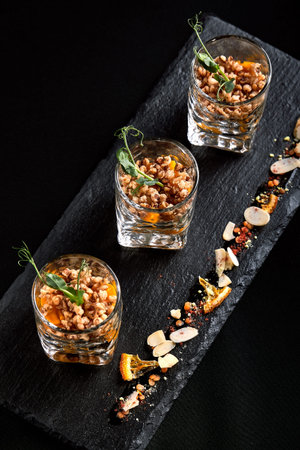 Healthy food, vegan vegetarian muesli made from green buckwheat and pumpkin seeds in a glass takan....