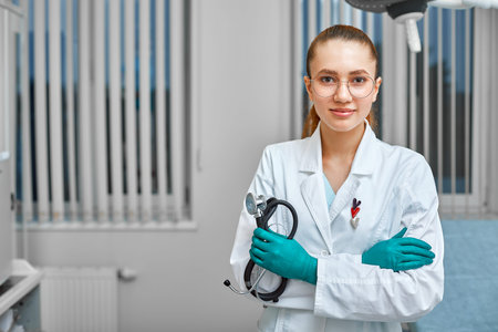 Portrait of happy successful young female doctor holding a stethoscope. Medical concept