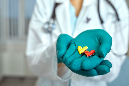 doctor holding simbols of heart in hand with medical care concept, Medicine in hospital, cardiology