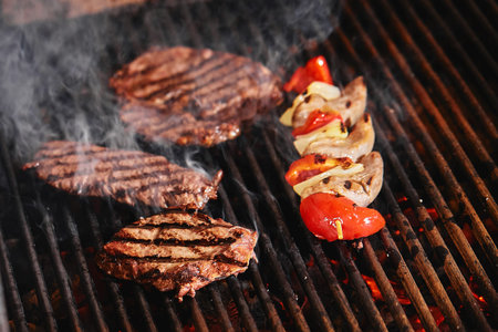 Juicy beef steak flips in a barbecue flame, life style, food photo, copy space.