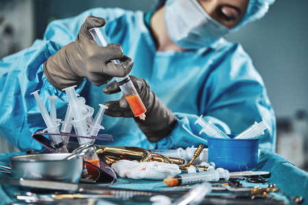 A set of operations for transplanting fat. Assistant surgeon doing the separation of fat before transplantation. Plastic surgery, body fat, lipofilling, liposuction.の写真素材