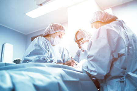 A team of doctors is fighting for the life of the patient. Intensive care unit, fight against viruses and bacretria, Covid 19. Pulmonary pneumonia is severe. Help the doctors, stay home.の写真素材