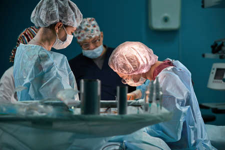 Group of surgeons in operating theater. Medical team performing surgery in operation room.の写真素材