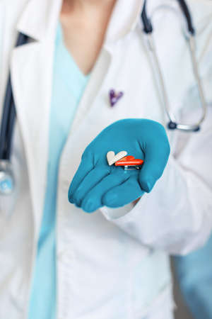 doctor holding medical drugs, pills, pills, hands with glovesの写真素材