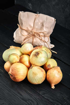 onions on a dark background, dark background, delivery, Organic products, layout for a healthy diet and organic advertising of restaurant cookingの写真素材