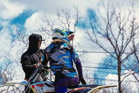 two moto bikers are ready to go and looking up for the trail