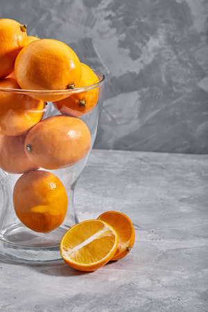 Fresh ripe oranges on gray stone background. Side view with copy spaceの写真素材