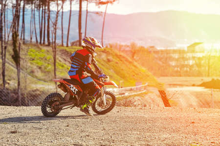 Close-up of biker sitting on motorcycle in starting point before the start of the raceの写真素材