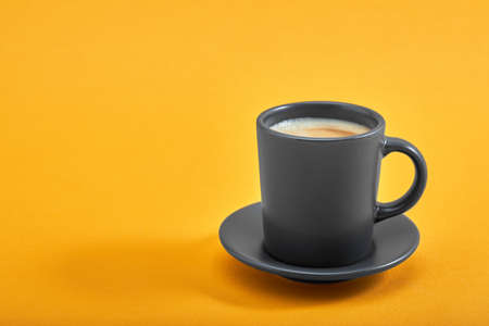 Cup of black coffee on a yellow background. Concept: Good morning, energy boost, motivation. Space for textの写真素材