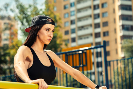 Photo of young european woman on a street workout in sports park on sunny day. Concept of training...