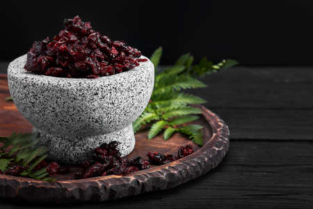 Dried cherry in a bowl over gray background. Top view.の写真素材