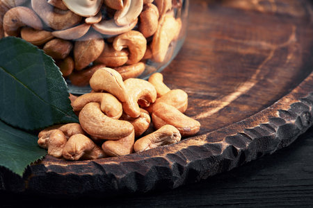 Bowl with cashew nuts on wooden table. Delicaciesの写真素材