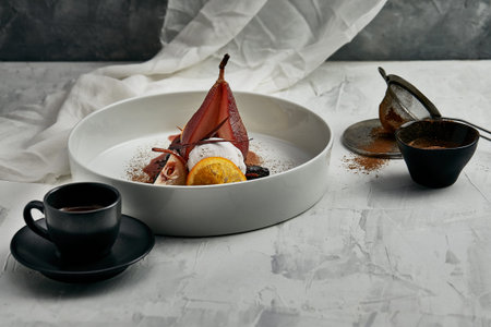 Poached pear with an ice cream in red wine sauceの写真素材
