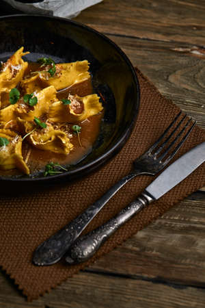 Italian ravioli stuffed with meat closeup on a black plate. rustic styleの写真素材