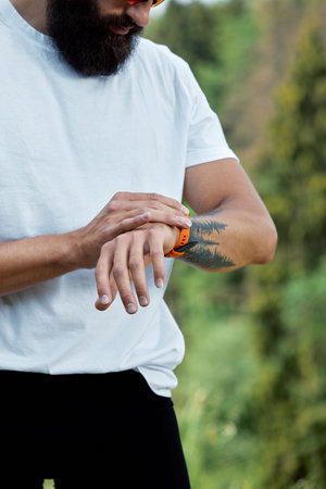 Healthy smart lifestyle concept. Muscular athlete doing great exercising outside in sunny park....