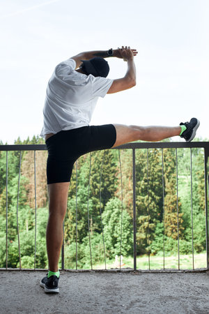 Concentrated male athlete running up stairs to make training more intensive. Sporty handsome young...