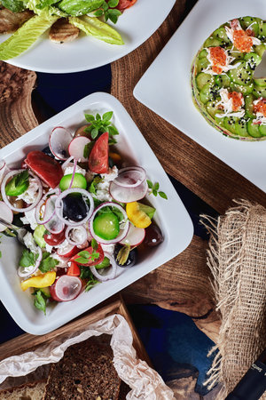 Classic Greek salad. Banquet festive dishes. Gourmet restaurant menu. White background.の写真素材