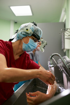 Doctor washes hands, disinfects hands before surgery in preparation room for surgery, medical team,...