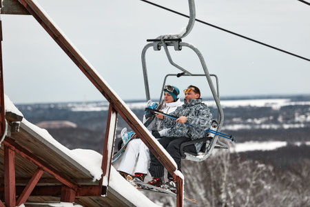 People using chairlift at mountain ski resort. Winter vacationの写真素材