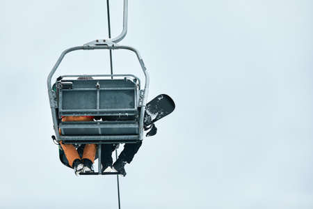 People using chairlift at mountain ski resort. Winter vacationの写真素材