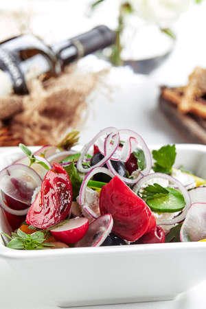 Classic Greek salad. Banquet festive dishes. Gourmet restaurant menu. White background.の写真素材