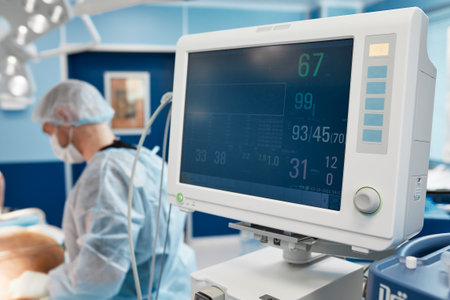 Anesthesiologist keeping track of vital functions of the body during cardiac surgery. Surgeon...