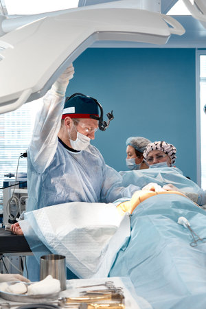Team surgeon at work in operating room.
