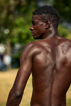 Shirtless african american man during workout, shot from the backの写真素材