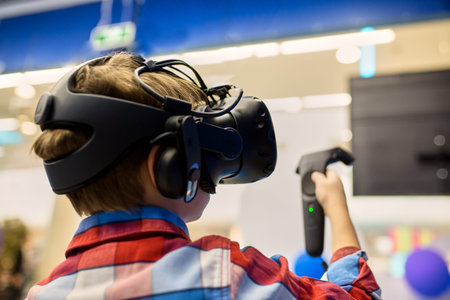 modern technology, gaming and people concept - boy in virtual reality headset or 3d glasses playing...
