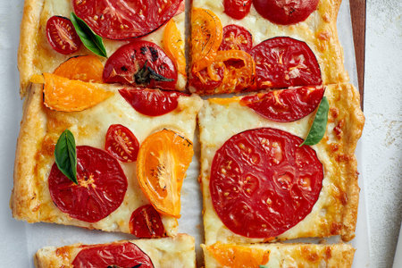 Baking pan with uncooked beef roulades and fresh vegetable trimmings ready for cooking on a white backgroundの写真素材