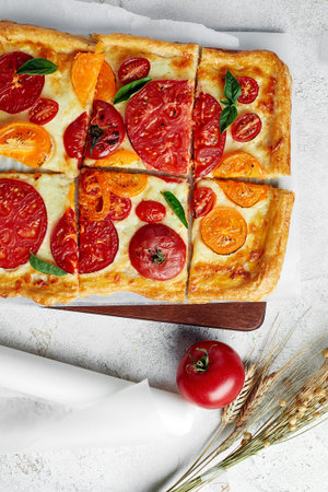 Delicious homemade square pizza with vegetables on whiteの写真素材