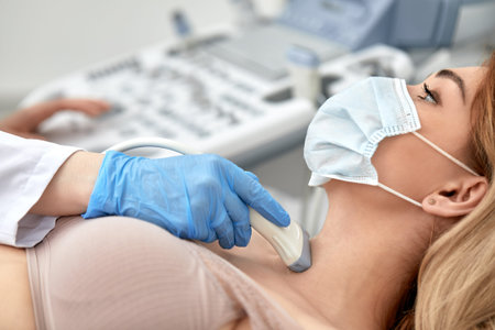 woman getting ultrasound of a thyroid from doctor
