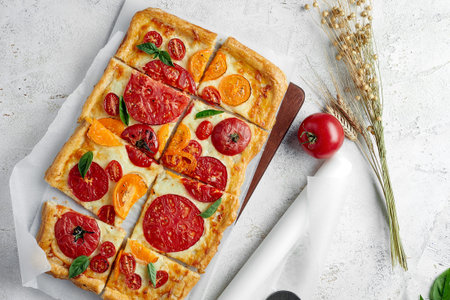 Delicious homemade square pizza with vegetables on white