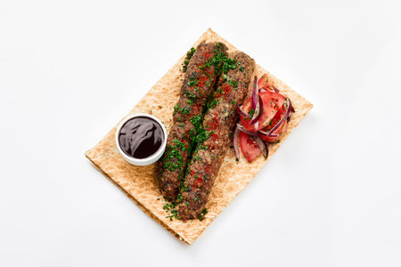 Lamb kebab on skewer on wooden board