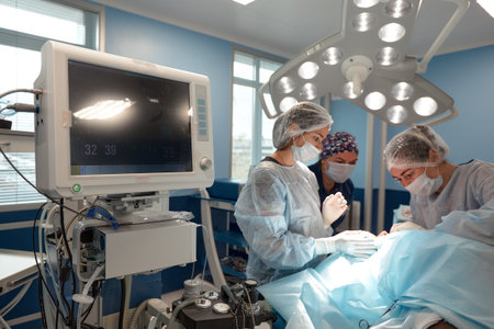 Concentrated Surgical team operating a patient in an operation theater. Well-trained...