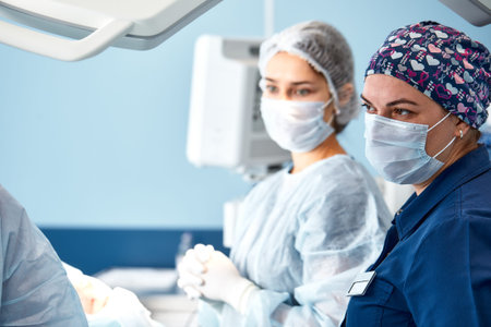 Concentrated Surgical team operating a patient in an operation theater
