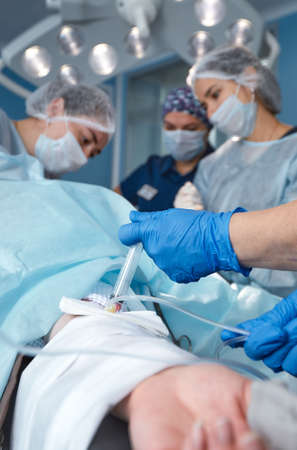 The patients hand is under the IV with a pulse oximeter on the finger. Medical services.の写真素材