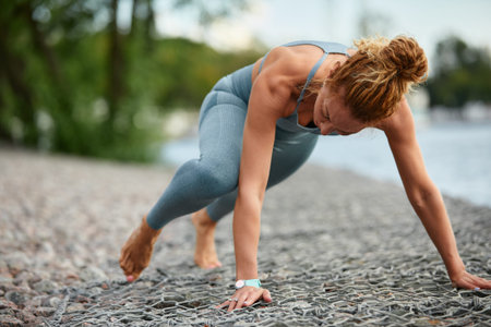 Blonde young athletic woman working out in a park in an urban environment. Attractive athletic woman...