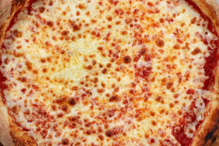 Selective focus traditional stone-baked pizza Margarita on stone tableの写真素材