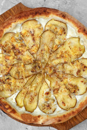 Pizza with pear, gorgonzola and on stone background. Top view.の写真素材