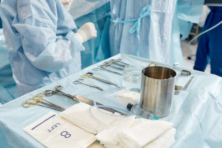 scrub nurse preparing medical instruments for operationの写真素材