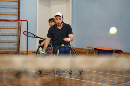 People in wheelchair playing tennis on court. Wheel Chair Tennis For Disabled.