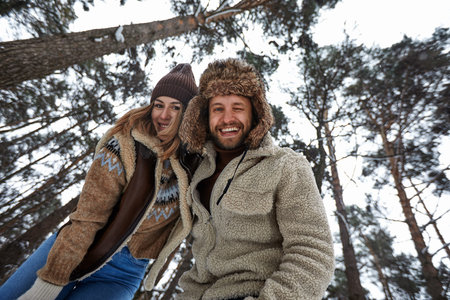 People, season, love and leisure concept - happy couple hugging and laughing outdoors in winter....