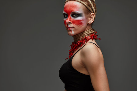 close up portrait of young beautiful girl with colorful face painting. Halloween professional...