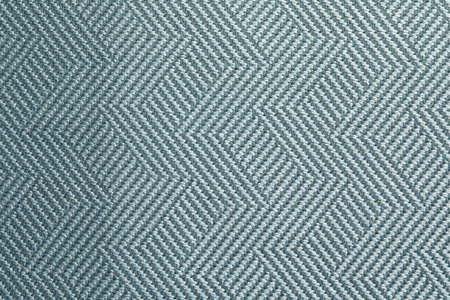 Knitted texture. Texture of jacquard fabric with gray blue geometric pattern. Crochet mosaic...