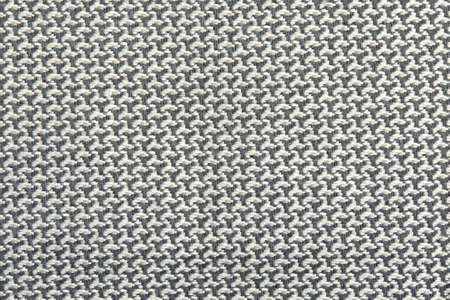 Knitted texture. Texture of jacquard fabric with gray geometric pattern. Crochet mosaic pattern.の写真素材