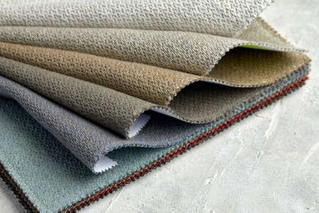 catalog of interior luxury fabric sample chart showing texture of fabric in pastel beige color tone. interior drapery and curtain samples palette.の写真素材