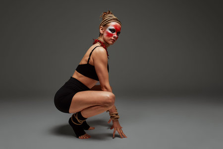 close up portrait of young beautiful girl with colorful face painting. Halloween professional makeup. neck and hands are wrapped with ropes. Victim Conceptの写真素材